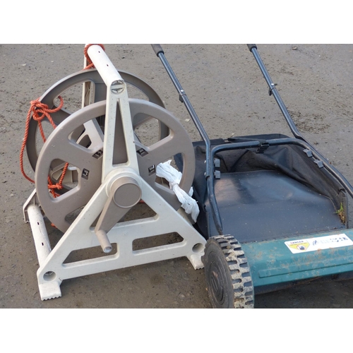 4 - A garden hose reel along with a push lawnmower.