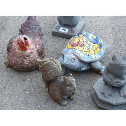 46 - A large assortment of garden ornaments and a planter.