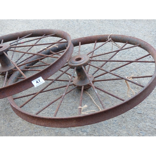 47 - A pair of antique cast metal bicycle rims.