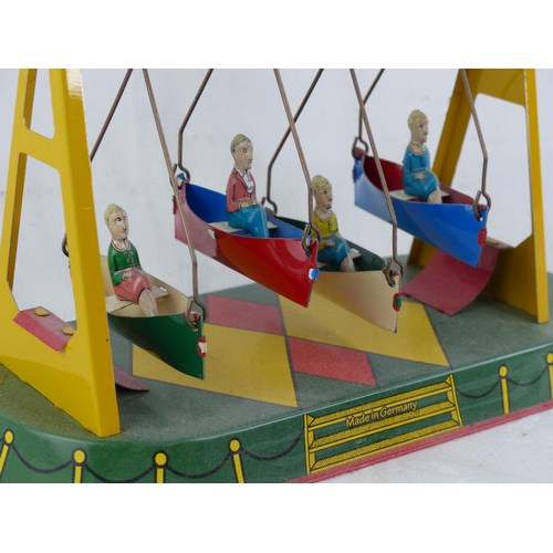 124 - A vintage German swing boat clockwork toy.