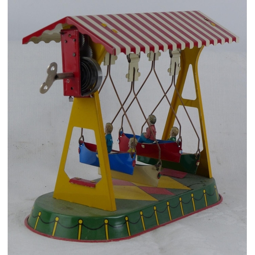 124 - A vintage German swing boat clockwork toy.