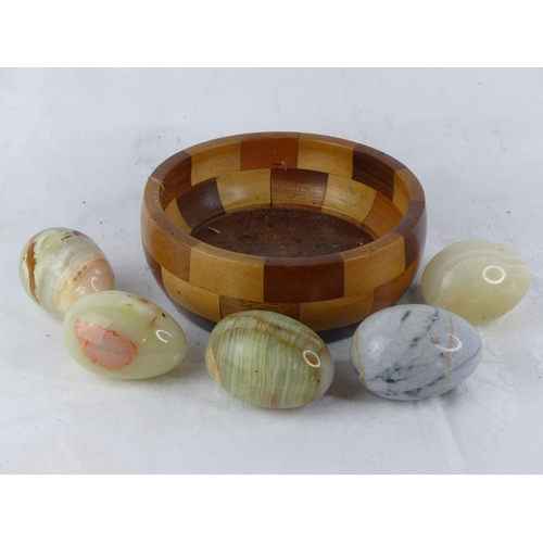 128 - A decorative wooden bowl and a lot of Connemara marble eggs.