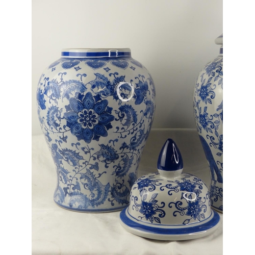 171 - A stunning pair of large blue and white patterned urns/ vases. 50cm tall