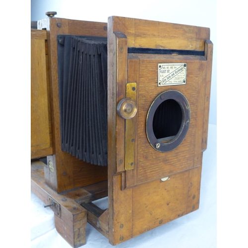 98 - An antique wooden cased magic lantern.