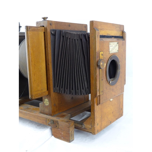 98 - An antique wooden cased magic lantern.