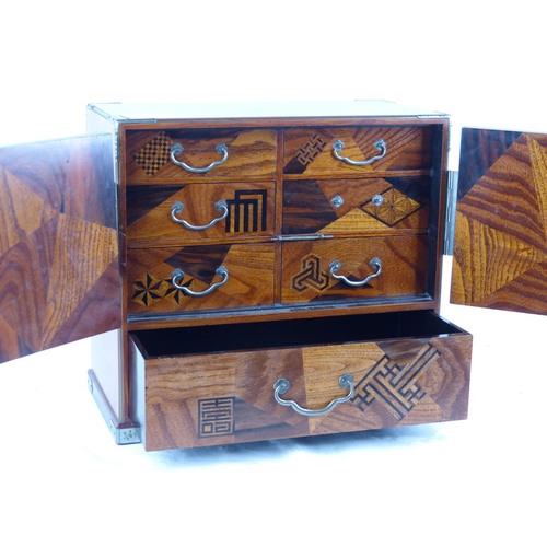 176 - A stunning miniature antique Japanese chest, with geometrical marquetry detail (one handle missing).