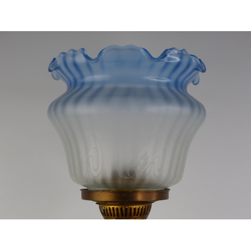 185 - A stunning antique Corinthian based oil lamp with blue glass shade.