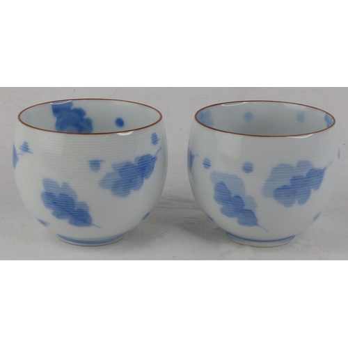 202 - A pair of antique Chinese blue and white patterned tea bowls, each signed to base.