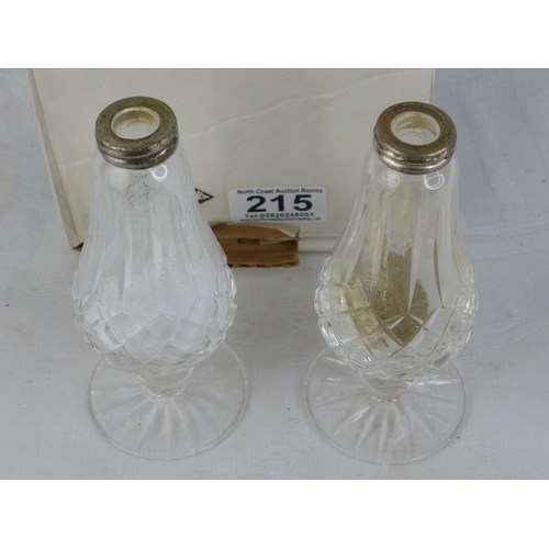215 - A boxed pair of Waterford crystal salt and pepper shaker (lacking stoppers).