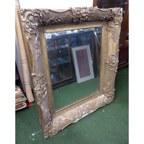 220 - A large antique heavy framed wall mirror with decorative gilt frame.. 1,6 meters x 88cm