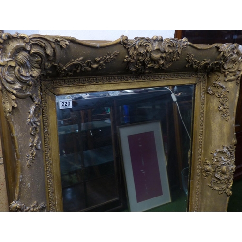 220 - A large antique heavy framed wall mirror with decorative gilt frame.. 1,6 meters x 88cm