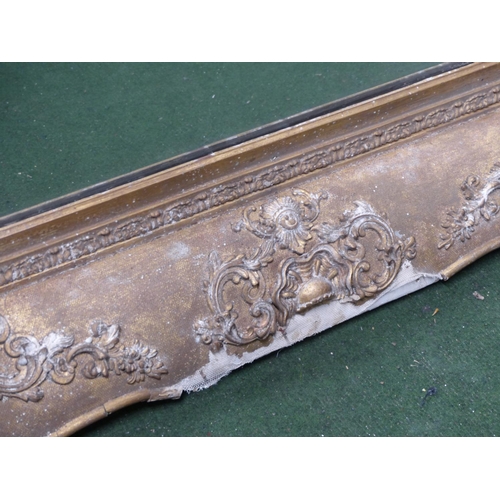 220 - A large antique heavy framed wall mirror with decorative gilt frame.. 1,6 meters x 88cm