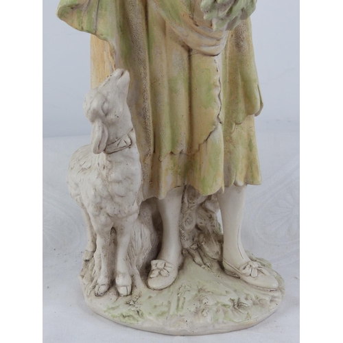 222 - An antique style chalk ware figure of a girl with goat.