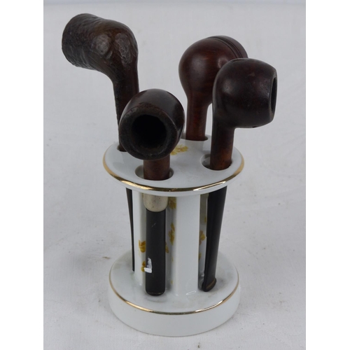 231 - A vintage ceramic pipe stand and four pipes.