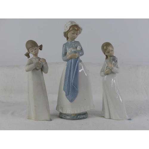 520 - Two Lladro figures and another.