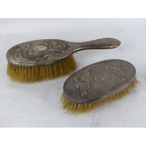 532 - Two Chinese Export Silver backed dressing table brushes with dragon design.