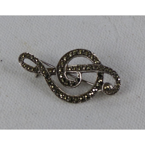 550 - A vintage Silver and Marcasite treble cleft brooch.