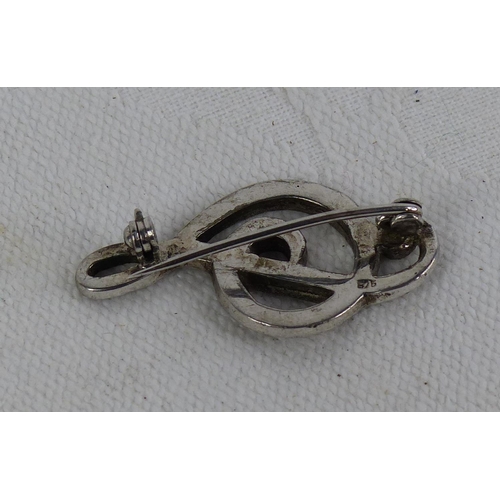 550 - A vintage Silver and Marcasite treble cleft brooch.