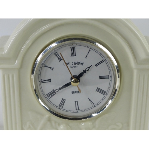 22 - A Belleek pottery 'Cottage' tealight holder and vase and a similar style clock.