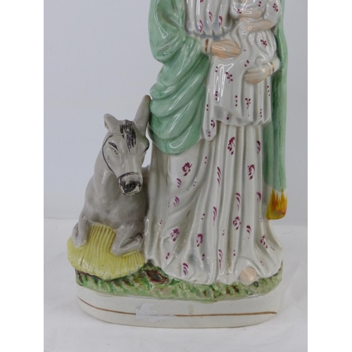 30 - An antique Staffordshire figure, 'Mary and Child', measuring 13