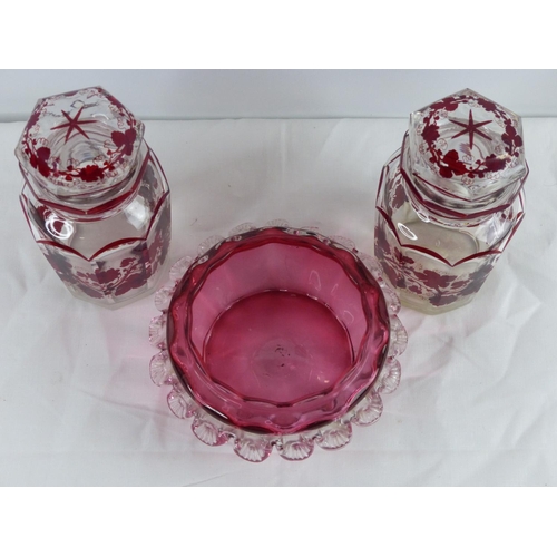 5 - An antique ruby glass bowl & pair of decorative lidded jars (a/f).