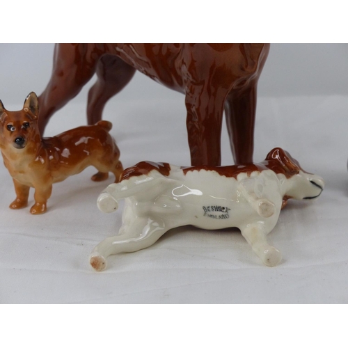 50 - A collection of three Beswick and a Royal Doulton dog ornaments.