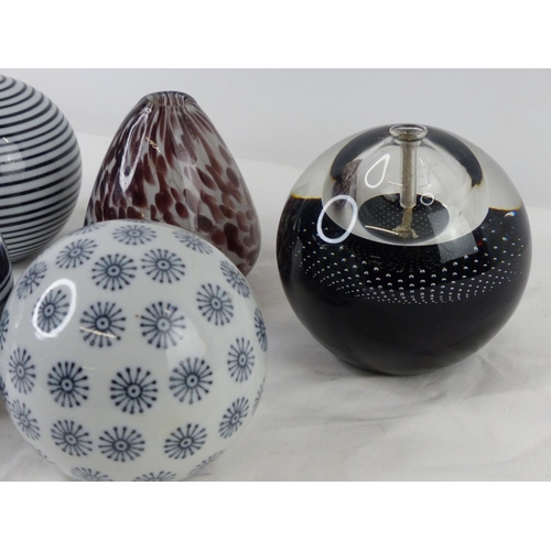 57 - Two glass paperweights and three ceramic patterned balls.