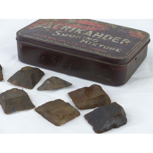 62 - A collection of antique flints in a Afrikander tin box.