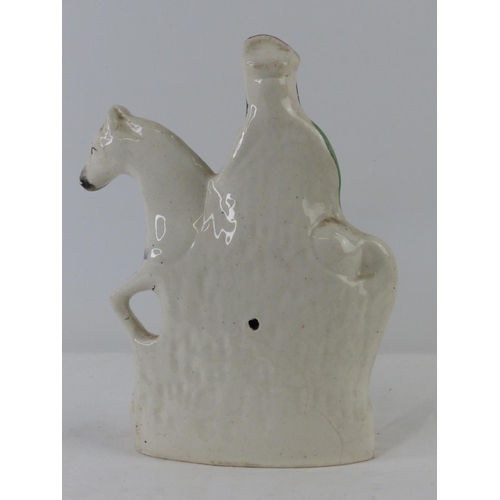 86 - A small antique Staffordshire figure, 'Horse & Rider', measuring 20cm.