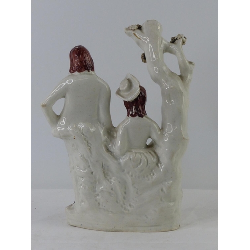 88 - An antique Staffordshire figure, 'The Lady and Gentleman' measuring 25cm.