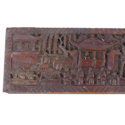 98 - A carved wooden panel with Oriental design, measuring 23cm x 8.5cm.