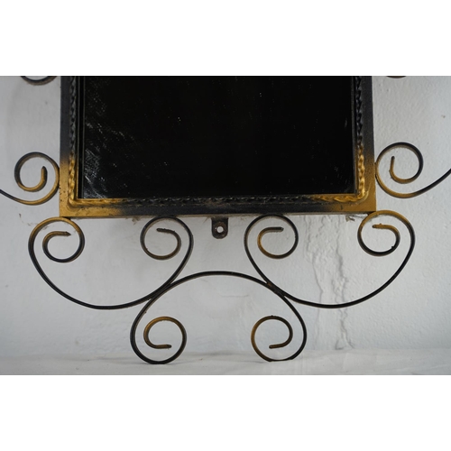 116 - A vintage wrought iron wall mirror, measuring 77cm x 54cm.