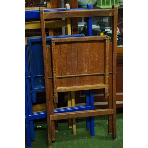 133 - Four wooden folding chairs.