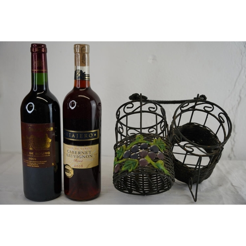 134 - A metal wine holder and two bottles of wine.