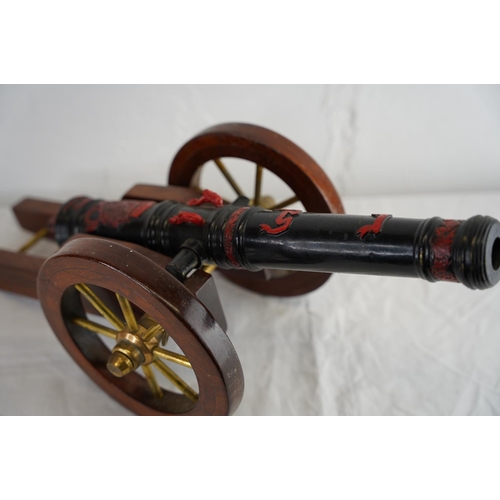 140 - A vintage/ antique hand painted model of a Louis XIV model cannon, measuring 53cm x 22cm.