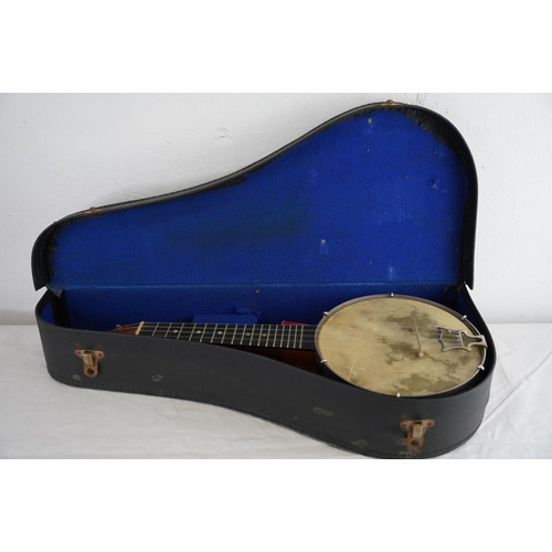 142 - A vintage cased John Grey & Son, London banjo.