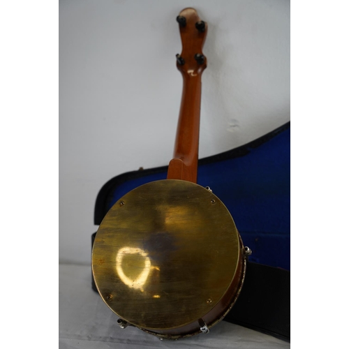 142 - A vintage cased John Grey & Son, London banjo.