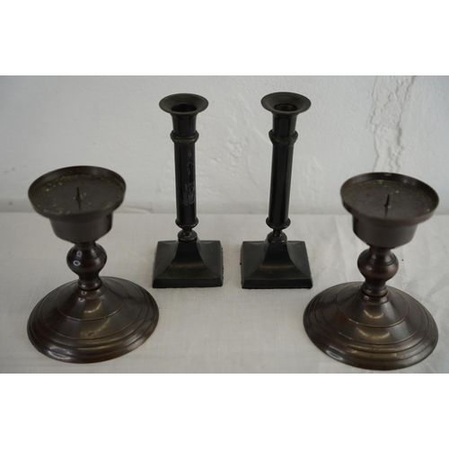 149 - Two pairs of metal candlesticks.