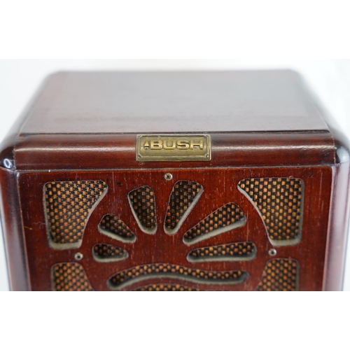 154 - An antique style Bush wood cased radio, measuring 33x24cm.