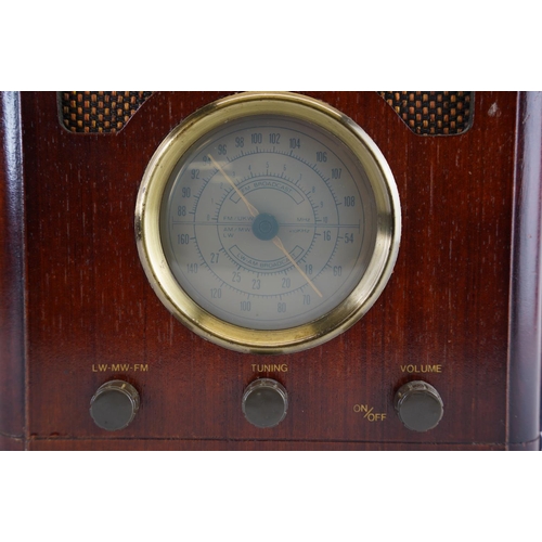 154 - An antique style Bush wood cased radio, measuring 33x24cm.