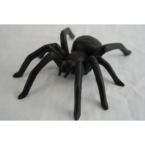 169 - A cast metal spider, measuring 15cm x 14cm and cast brass hand.