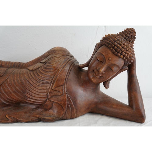 180 - A large wooden reclining Buddha, 64cm.