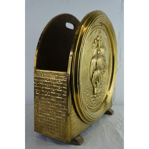 186 - A vintage brass magazine rack with ship design.