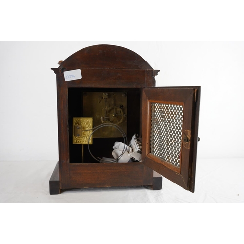 208 - A Walnut cased mantle clock with brass dial, measuring 36cm x 25cm,