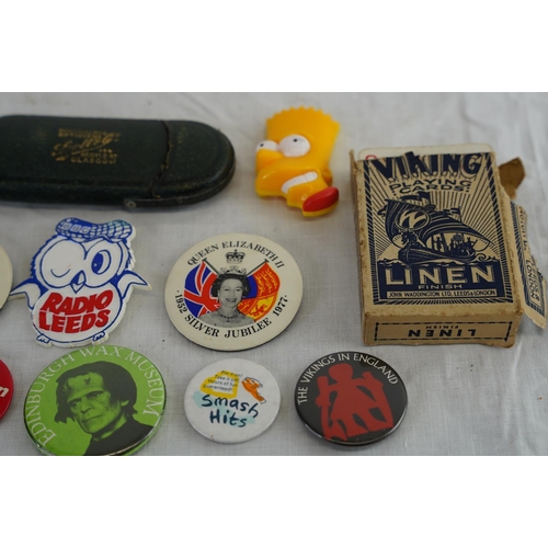 222 - A collection of items to include assortment of vintage pin badges & set of Viking playing cards.