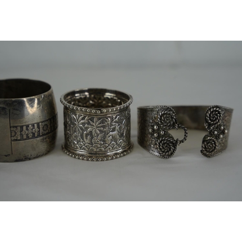 252 - Three Sterling silver napkins and a Sterling silver bangle. 119g.