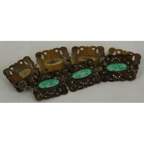 291 - A decorative metal bracelet with gemstone detail.