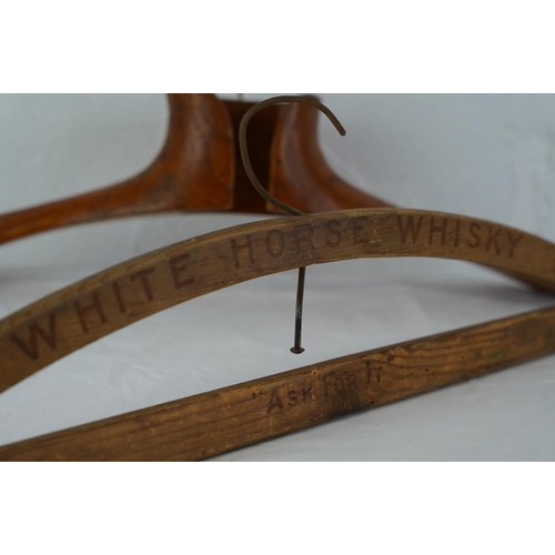 301 - A vintage wooden 'White Horse Whisky - Ask for It' advertising coat hanger and another.