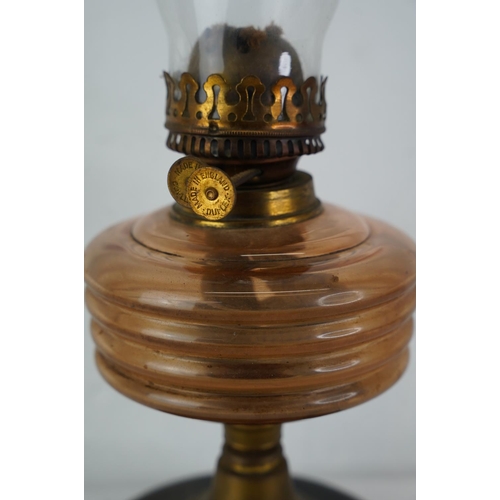 311 - A vintage oil lamp with amber glass font.