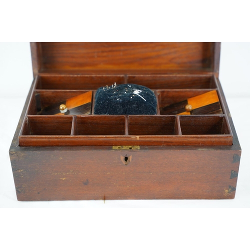 312 - A wood cased sewing box, measuring 33cm x 20cm.